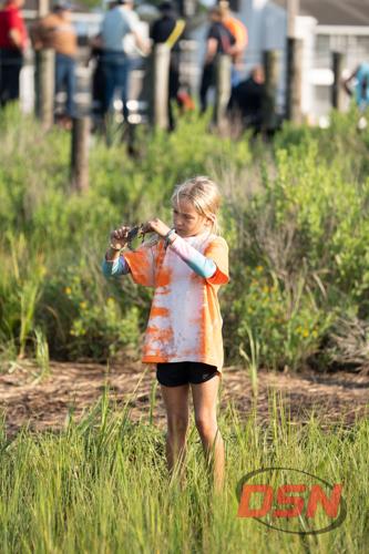 Girl holding a crab in the Chincoteague marsh.jpg