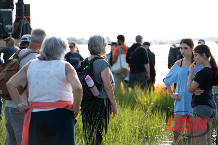 Spectators gathered by the water at sunset.jpg
