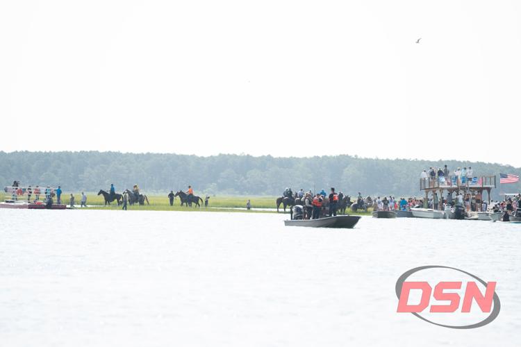Saltwater Cowboys on horseback gathering across the channel.jpg