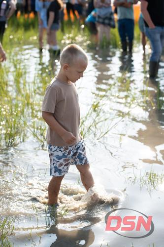 Boy splashing through the marsh water.jpg