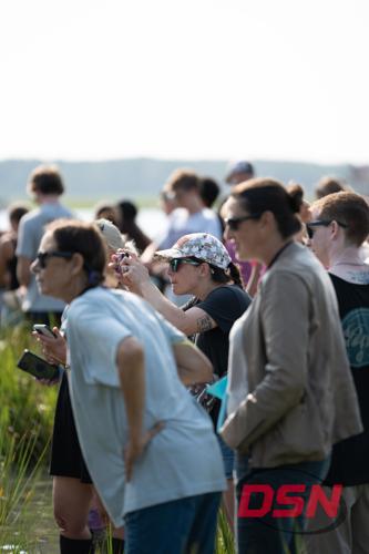Spectators taking photos with a camera by the water.jpg