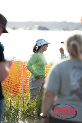 Woman in a green shirt chatting in the crowd.jpg