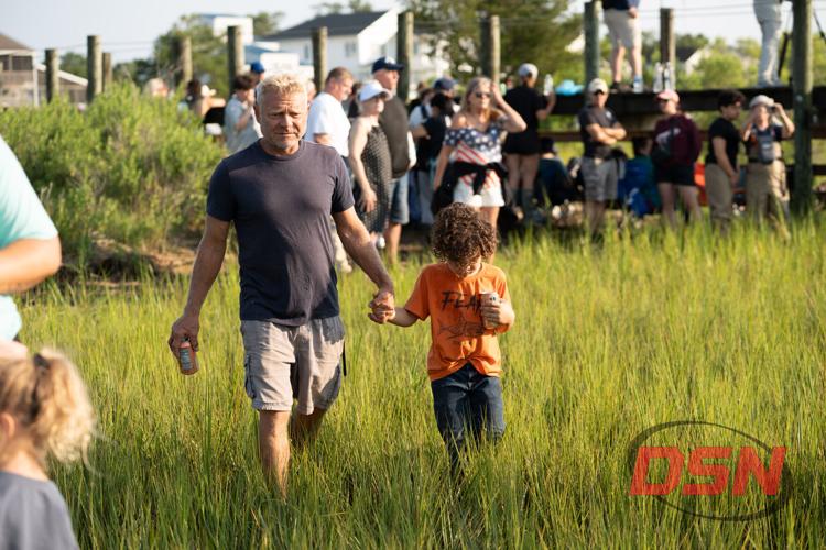 Father and son walking through the marsh grass.jpg