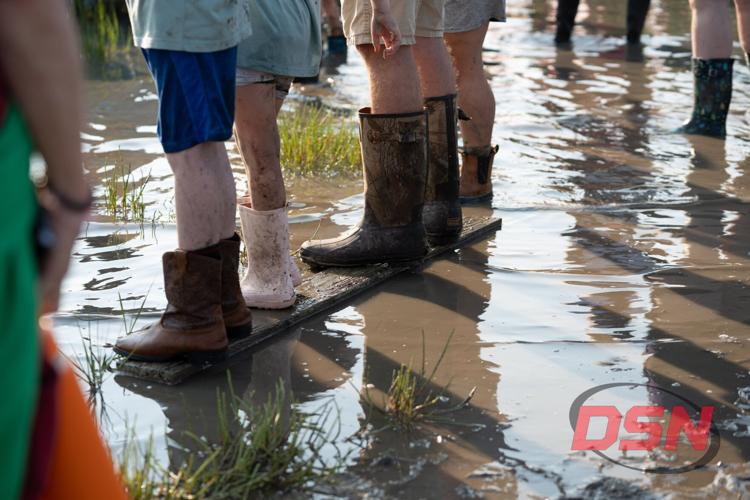 Muddy boots on a wooden plank over the water.jpg