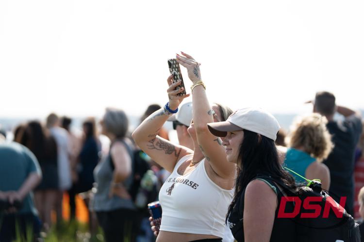 Woman with tattoos taking a photo overhead with her phone.jpg