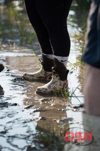 Muddy boots standing in the marsh water.jpg