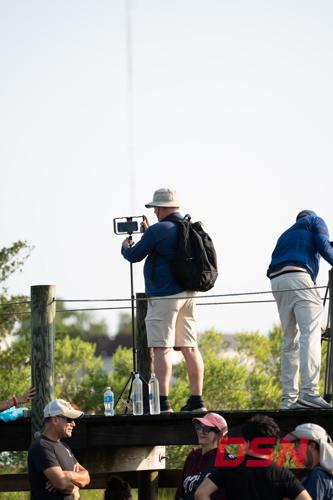Man filming the Pony Swim with his phone on a tripod.jpg