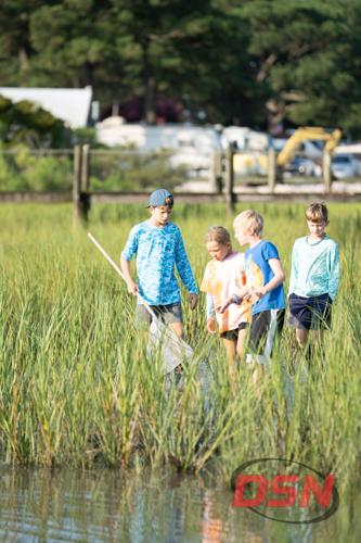 Kids netting for critters in the marsh water.jpg