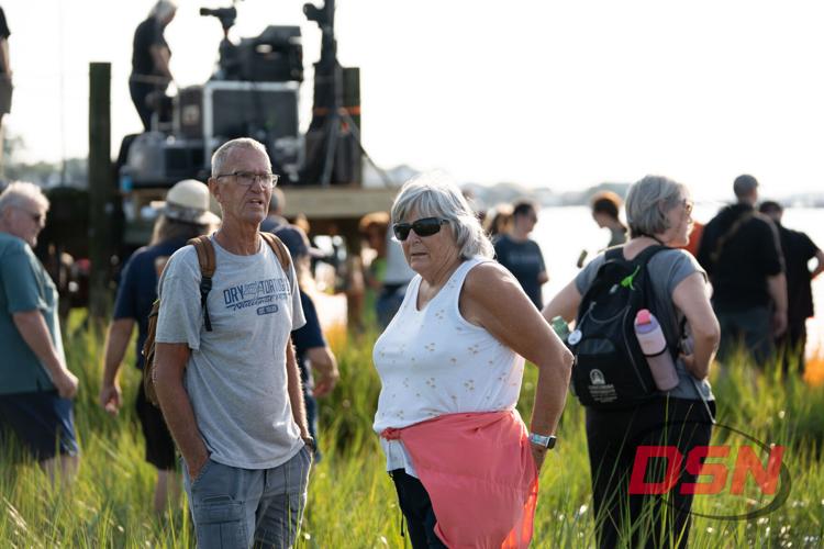 Couple standing in the marsh grass by the water.jpg