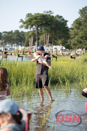 Man holding a baby in the marsh water.jpg