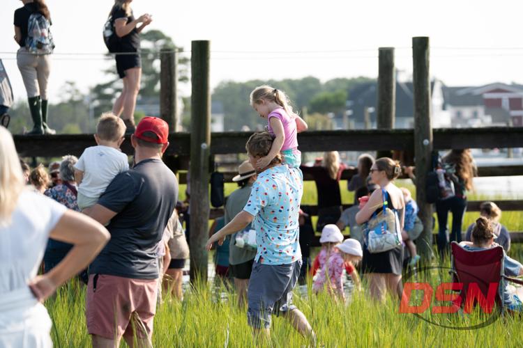 Girl riding on a man's shoulders through the crowd.jpg