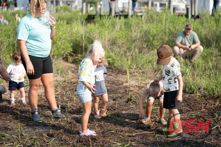 Toddlers playing in the marsh grass and mud.jpg