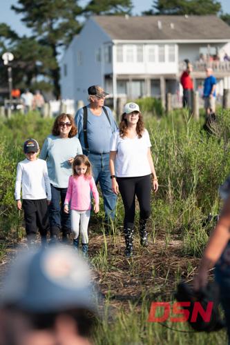 Family walking through the marsh, woman wearing pony print boots.jpg