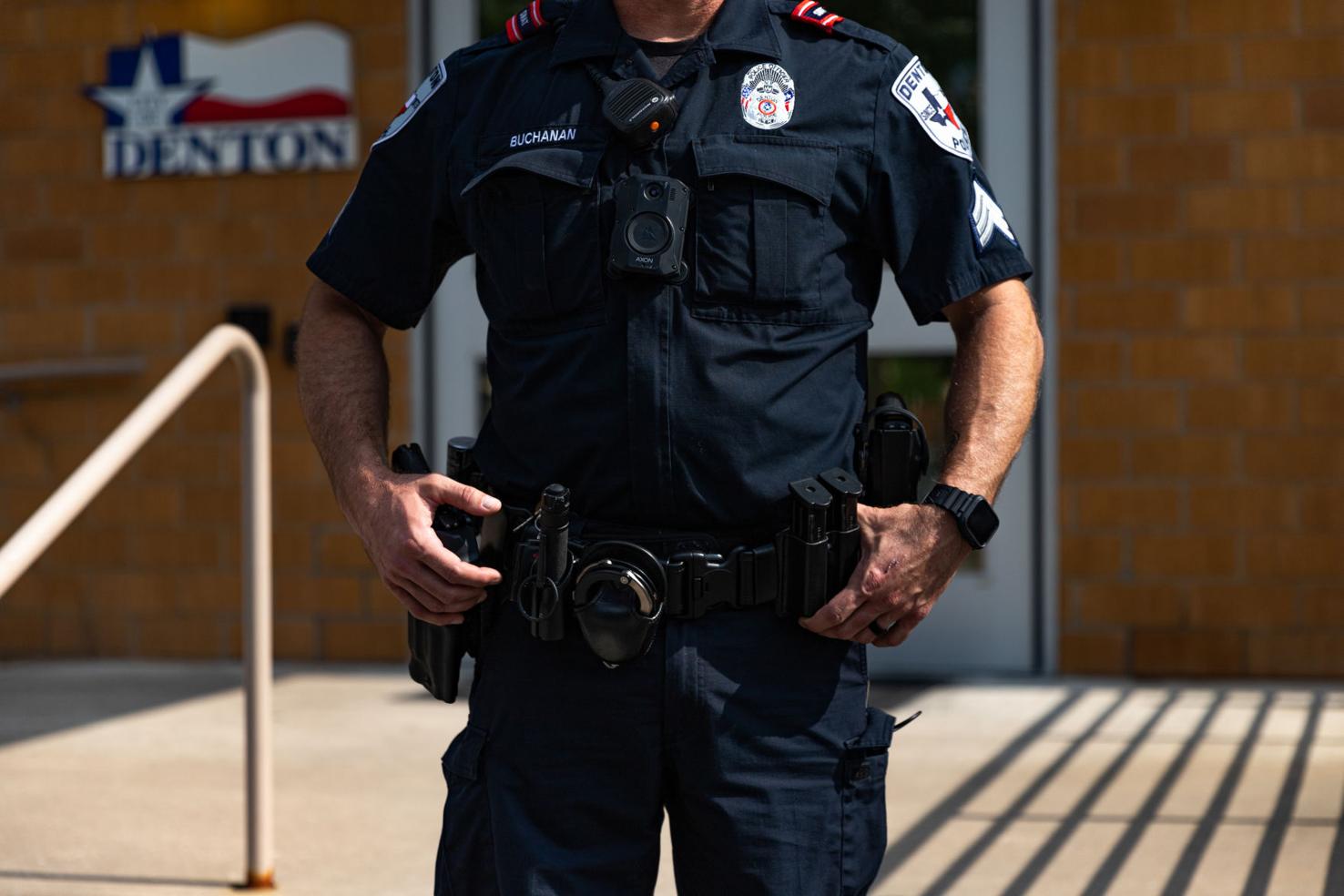 What do Denton police officers carry on their belts and in their cars
