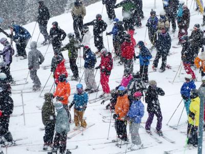 Skiers Waiting in a Chair Lift Line Photo Credit: KaraGrubis (iStock).