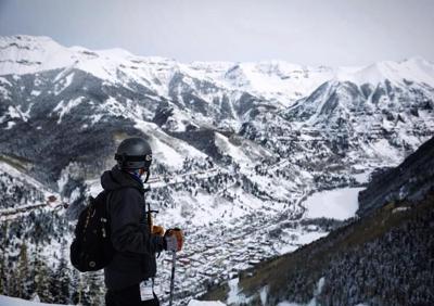 Spencer McKee of the OutThere Colorado team looks toward the town of Telluride from the slopes of Telluride Ski Resort. Photo Credit: Stephen Martin.