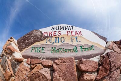 This previous summit sign lists the mountain as 14,110 feet tall. The new summit sign on the summit of Pikes Peak now reads 14,115 feet, but new data indicates that's wrong, too. Photo Credit: oscity (iStock).