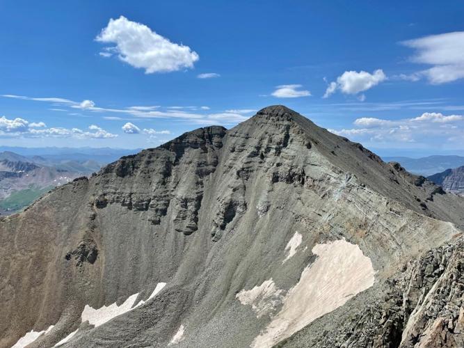 Castle Peak, as seen from the summit of Conundrum Peak. The standard route to the summit of Castle Peak can be seen as the faint trail along the ridge to the left of the image. The route between both peaks can be seen on the right side of the image. Pho...