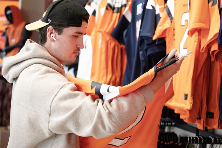 Kevin Bornhofen looks over several jersey options at the Broncos' team store