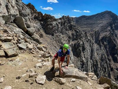 Spencer McKee approaches the final push of the Sawtooth Ridge. The ridge itself can be see directly behind him, along with a white line coming off of the upper right of his helmet that is part of the trail. The Mount Bierstadt summit can be see in the t...