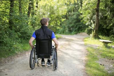 Disabled man on wheelchair in nature