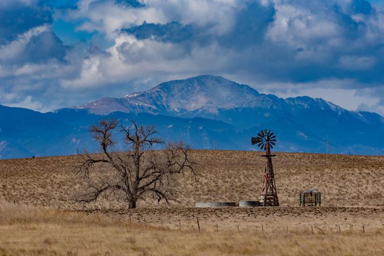 Old windmill with Pikes Peak in background Pikes Peak. Photo Credit: John Morrison (iStock).