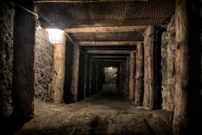 Coal mine underground corridor with wooden support system Photo Credit: ewg3D (iStock).