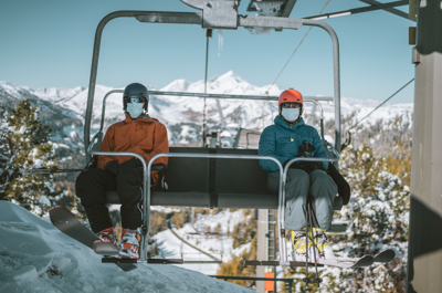 Socially distanced and masked skiers on a lift. Photo Credit: amriphoto (iStock).