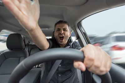 Young angry man driving his vehicle Photo Credit: shalunts (iStock).