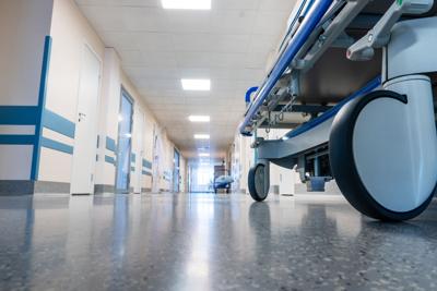 Medical bed on wheels in the hospital corridor.