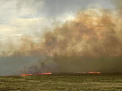 A line of fire burns across grasslands southwest of the dunes. Photo: National Park Service.