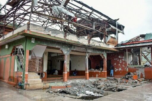 Muslims attend Friday prayers at a mosque damaged by an Indian strike in Muzaffarabad, capital of Pakistan-administered Kashmir