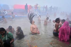 Photos show devotees taking a holy dip at Sangam during Mauni Amavasya festival in India