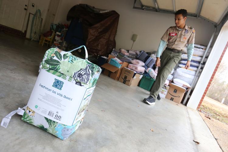Tupelo Boy Scout collecting donations, building beds for children as