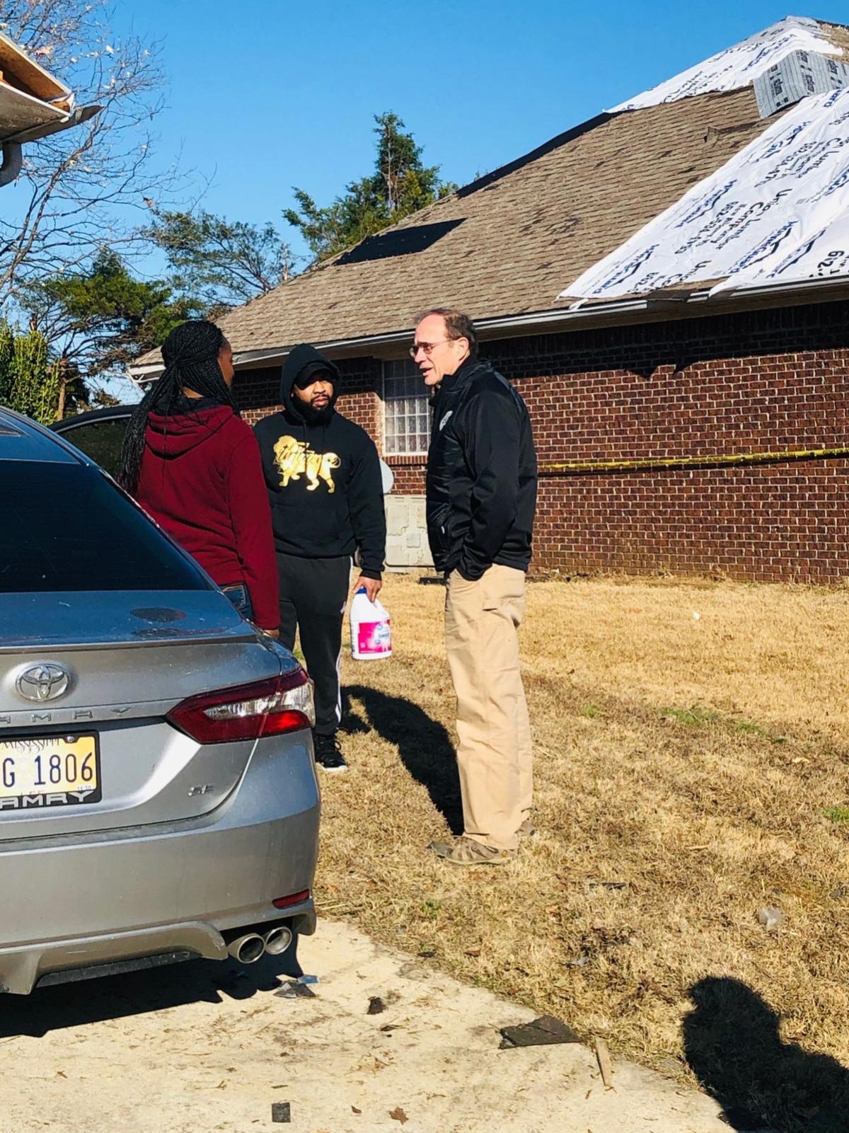 Delbert Hosemann visits with homeowners in Guntown