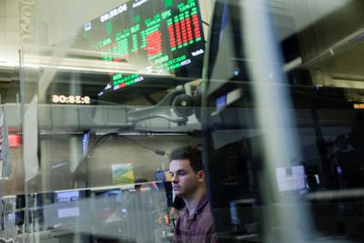 FILE PHOTO: A futures-options trader works on the floor at the New York Stock Exchange (NYSE) in New York City