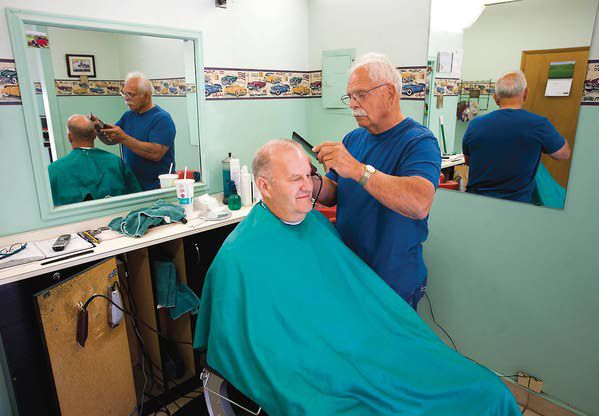 Albion barber cuts hair, supports children in community