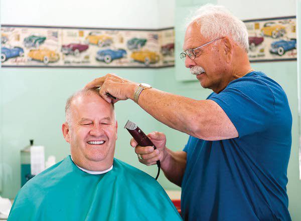 Albion barber cuts hair, supports children in community