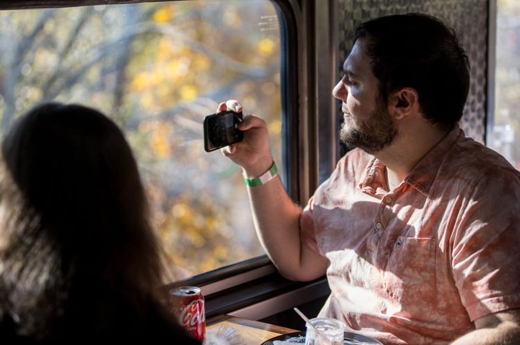 Young man looking out of train window on the historic steam engine