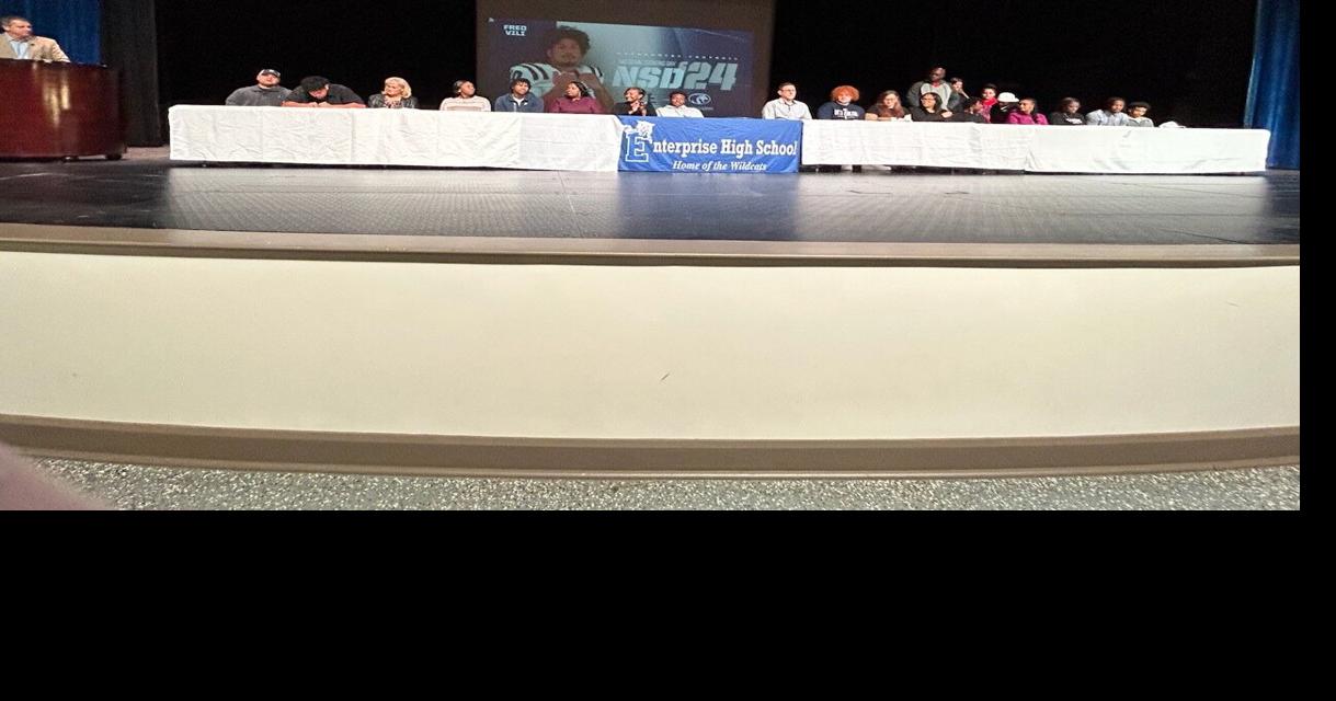 DothanEagle.com - Enterprise football players sign on the dotted line image