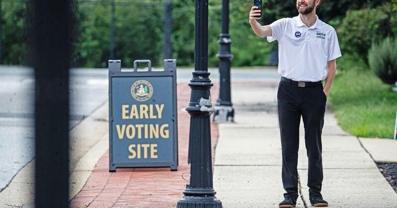 Michael Smith, a Democratic candidate for state treasurer, takes a selfie outside The Delaware Contemporary, an early voting