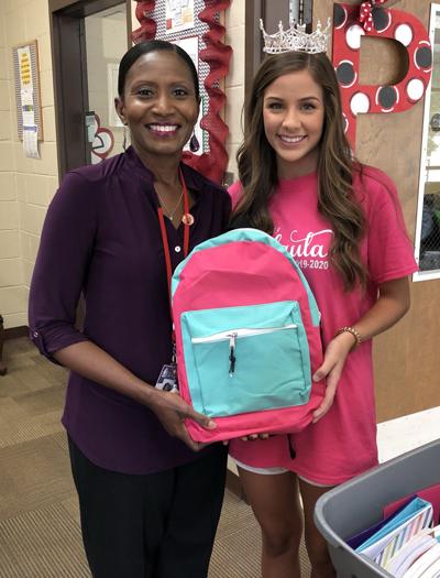 Queen helps collect supplies for school