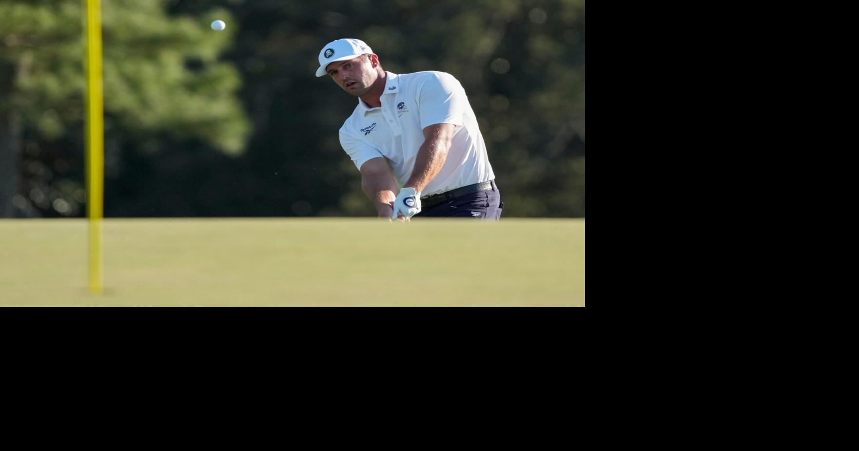 Bryson DeChambeau chips onto the 18th green during the second round of the Masters Tournament at Augusta National Golf Club.