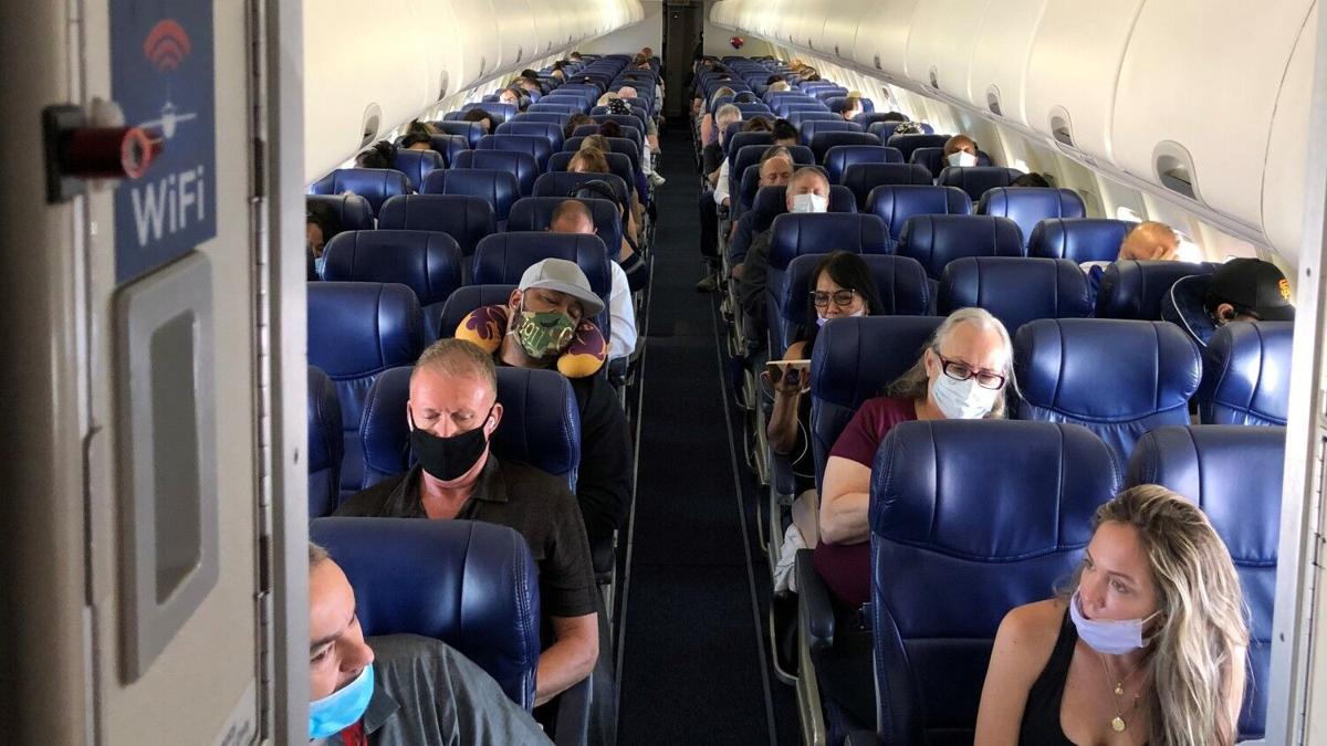 Masked passengers fill a Southwest Airlines flight from Burbank to Las Vegas in June of 2020, with middle seats left open.