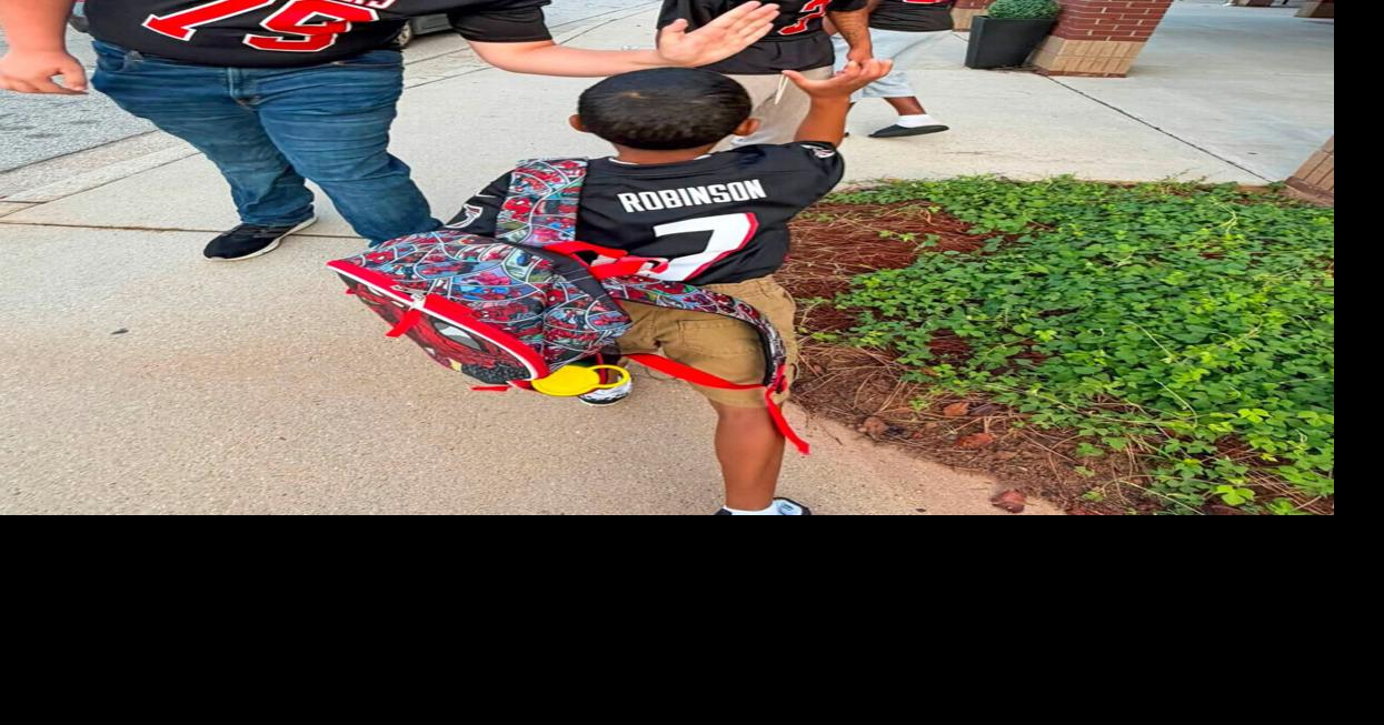 Alexander student-athletes surprise elementary students with morning greeting