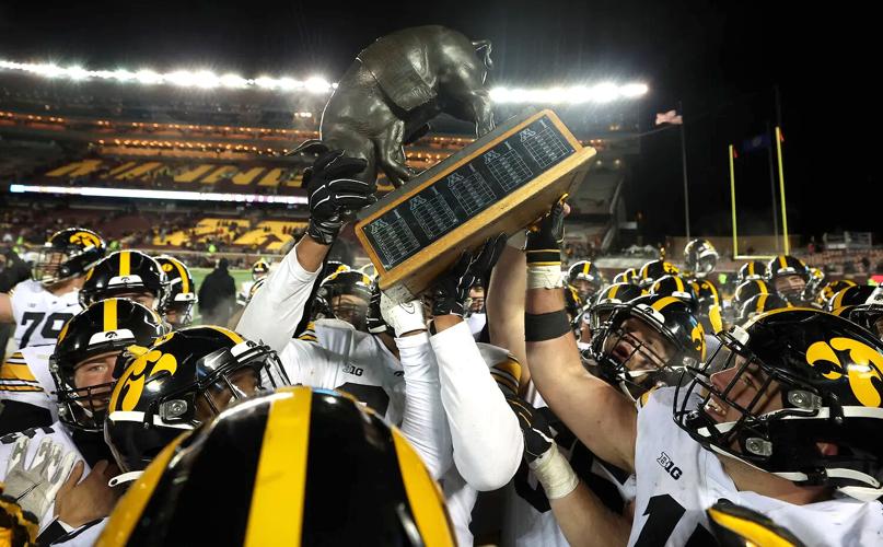Hawkeyes celebrate with the Floyd of Rosedale trophy