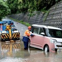 Two severe tropical storms are expected to converge over Japan, making forecasting their movements and strengths more difficult