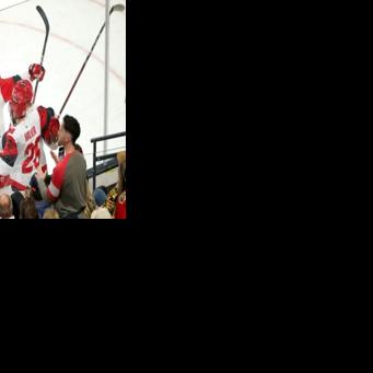 Jackson Blake of the Carolina Hurricanes celebrates with Sean Walker and Taylor Hall after scoring in the team's title-clinching game-six victory over the Vegas Golden Knights in the Stanley Cup Final