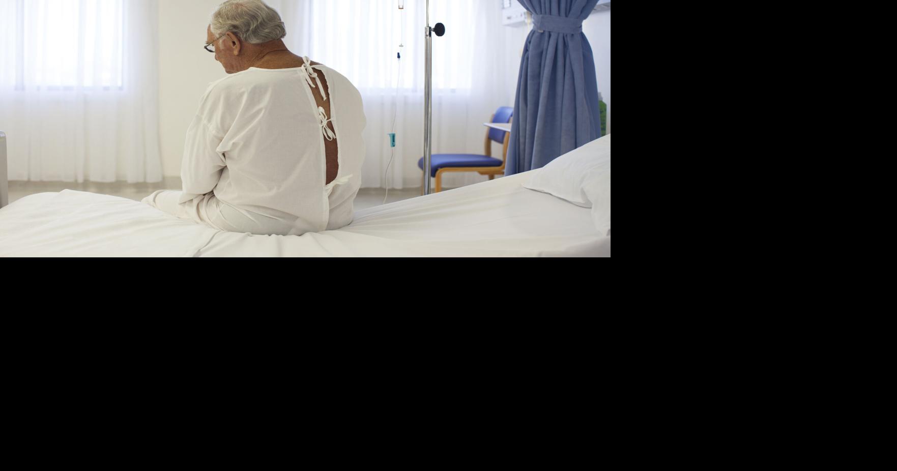 Older patient wearing gown in hospital room | | elvocero.com