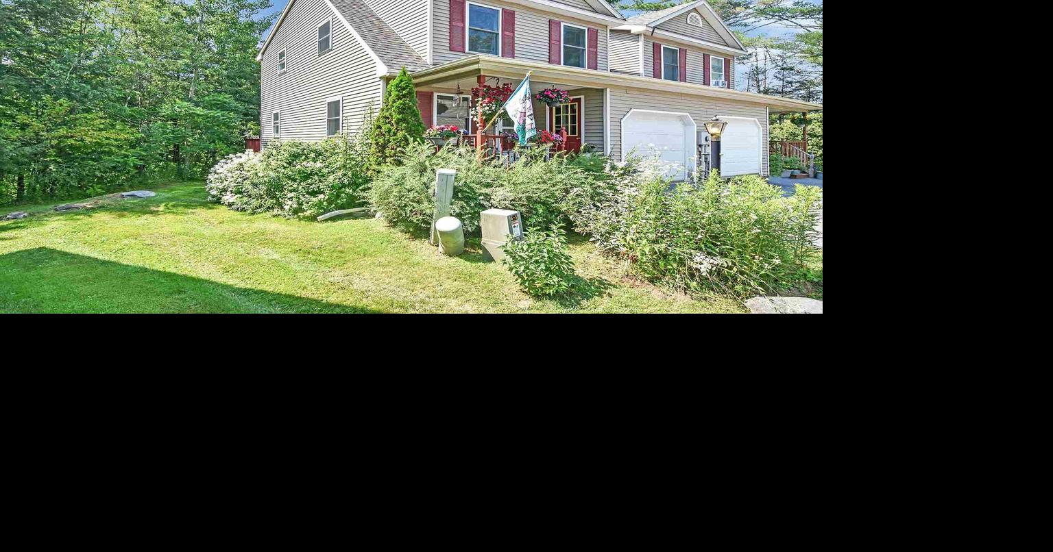 This Essex Junction condo has a deck overlooking a charming wooded